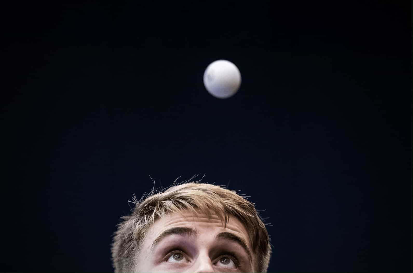 Truls Möregårdh, svensk bordtennisspelare tittar koncentrerat på en pingisboll som är uppe i luften. 
